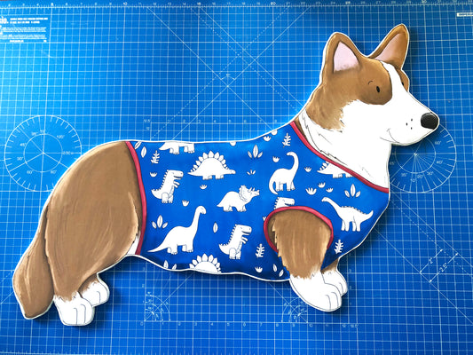 Corgi dressed in dinosaur PJs!