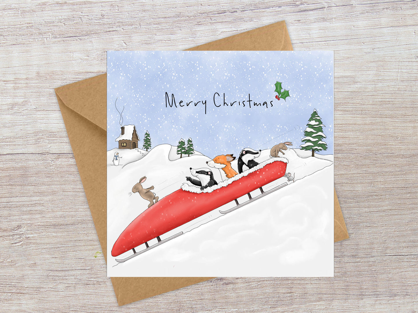 Toboggan full of woodland animals Christmas card