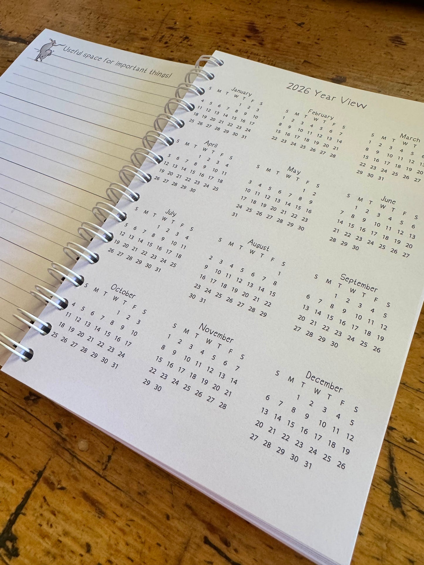 A6 wire bound week to view 2026 diary, featuring lots of characterful illustrations